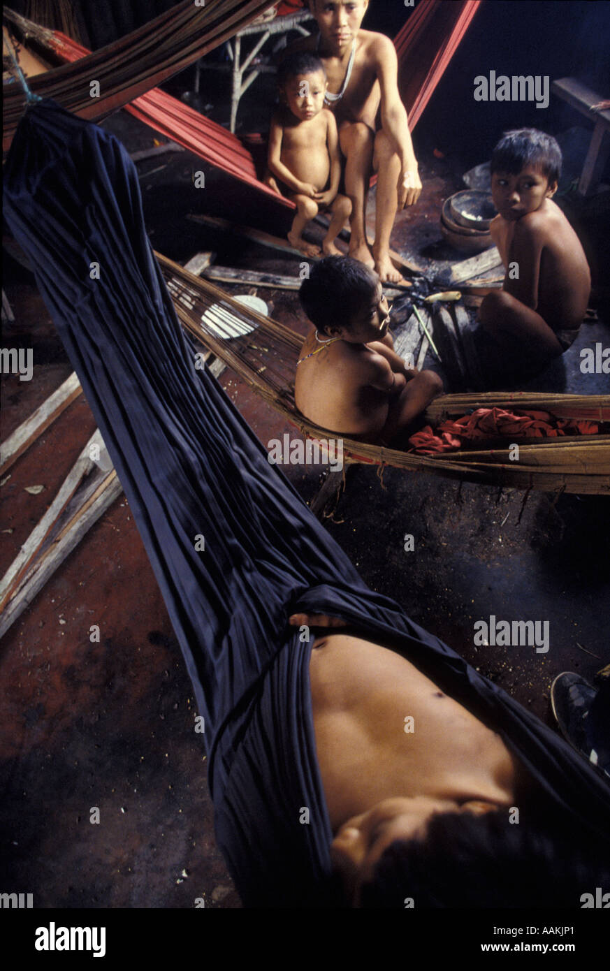 Yanomami indigenous people, family rests in hammocks. Surucucus, Roraima, Amazon rainforest, Brazil. Stock Photo