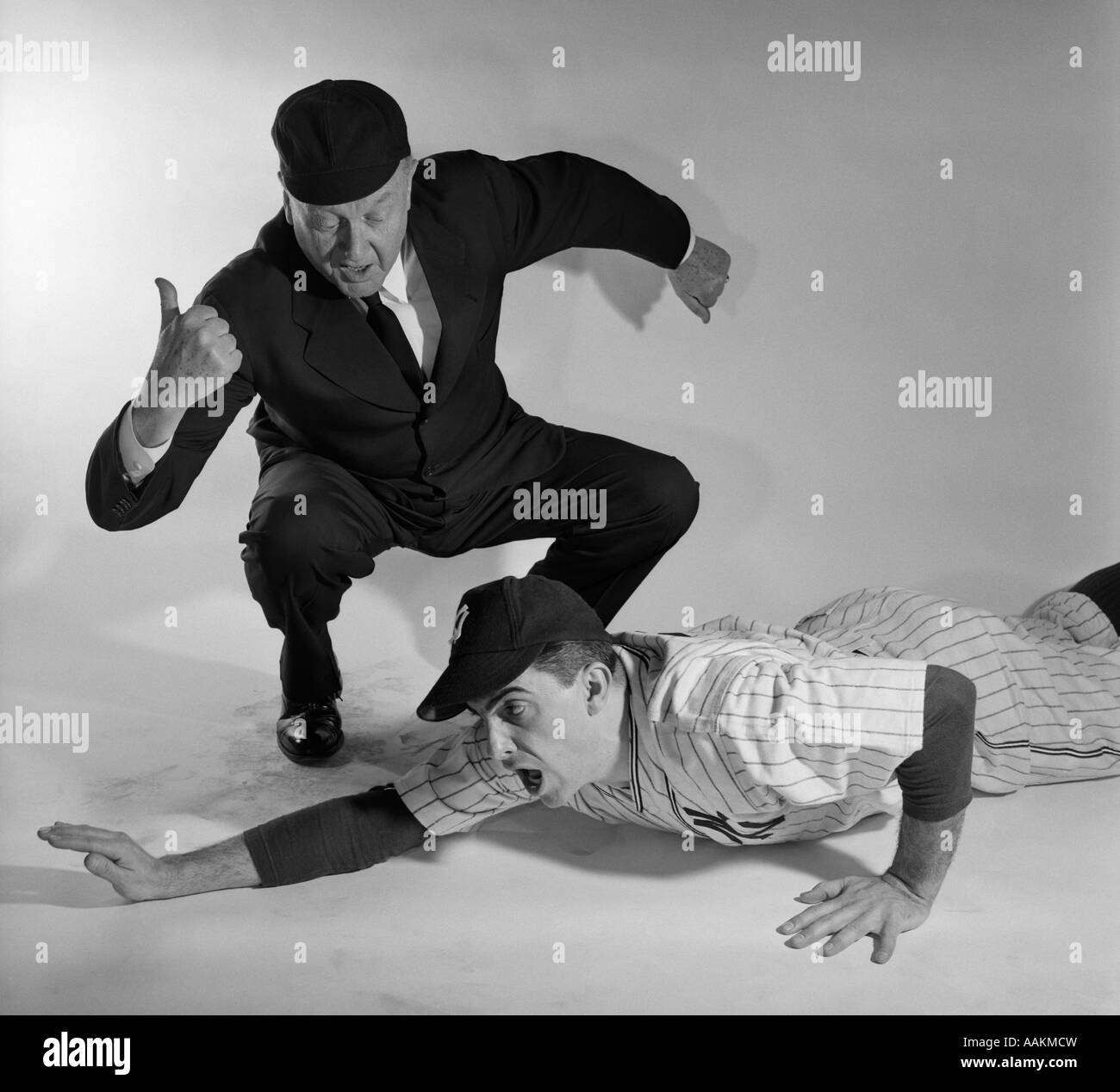 1950s BASEBALL UMPIRE CALLING SLIDING PLAYER OUT STUDIO SHOT Stock Photo
