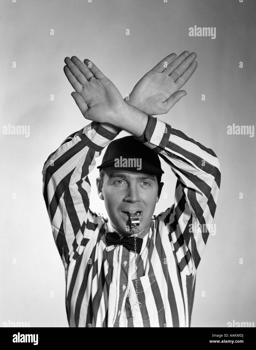 1950s FOOTBALL REFEREE MAKING HAND SIGNAL TIME OUT BLOWING WHISTLE Stock Photo