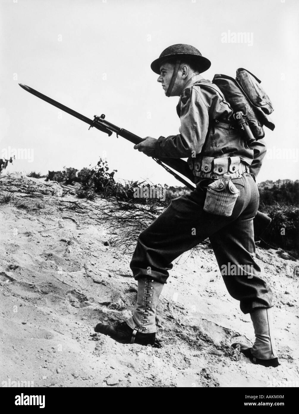 1940s 1942 WORLD WAR II SOLDIER WALKING ACROSS ROUGH TERRAIN WITH RIFLE AND  BAYONET IN HAND Stock Photo - Alamy