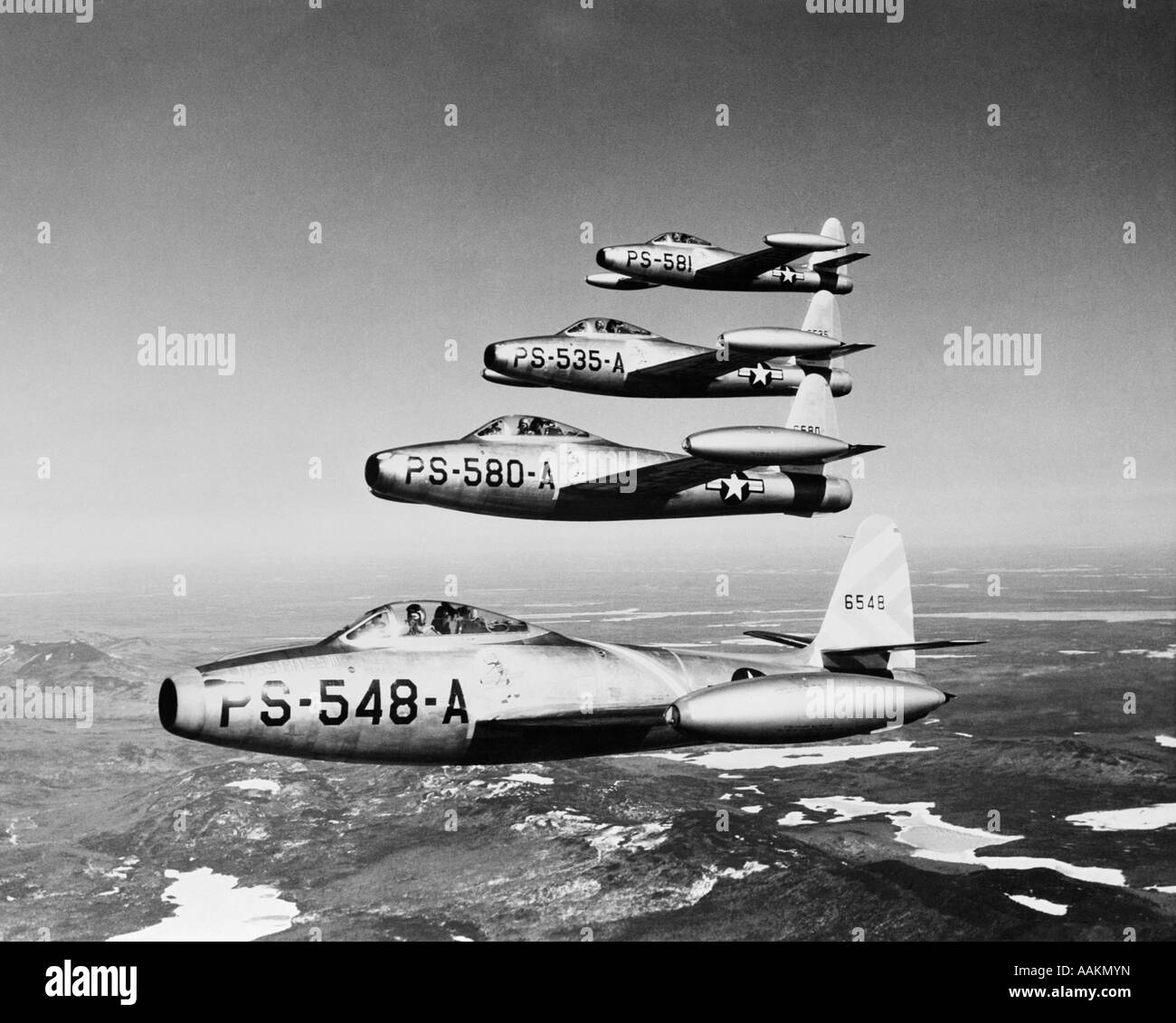1950s FOUR US AIR FORCE THUNDER JETS IN FLIGHT FORMATION Stock Photo