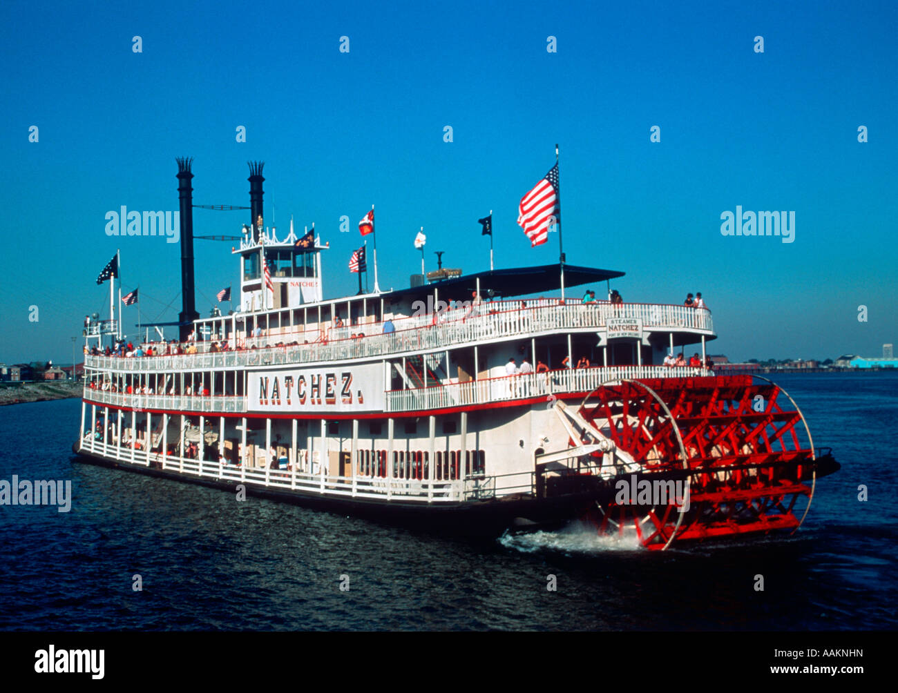THE PADDLE WHEEL BOAT THE NATCHEZ IN MISSISSIPPI RIVER AT 
