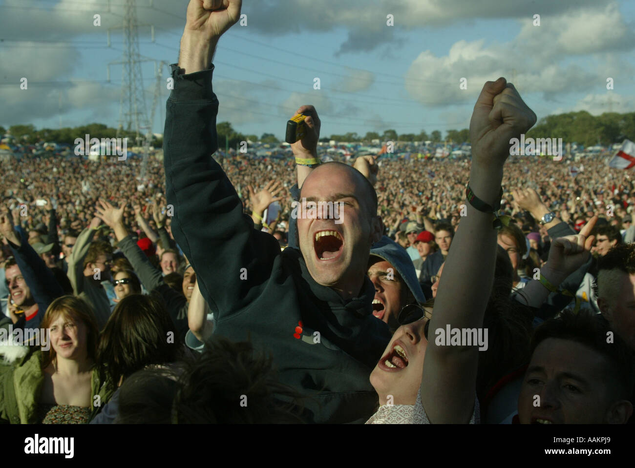 People cheer wildly at the main stage at the Glastonbury Festival. Stock Photo
