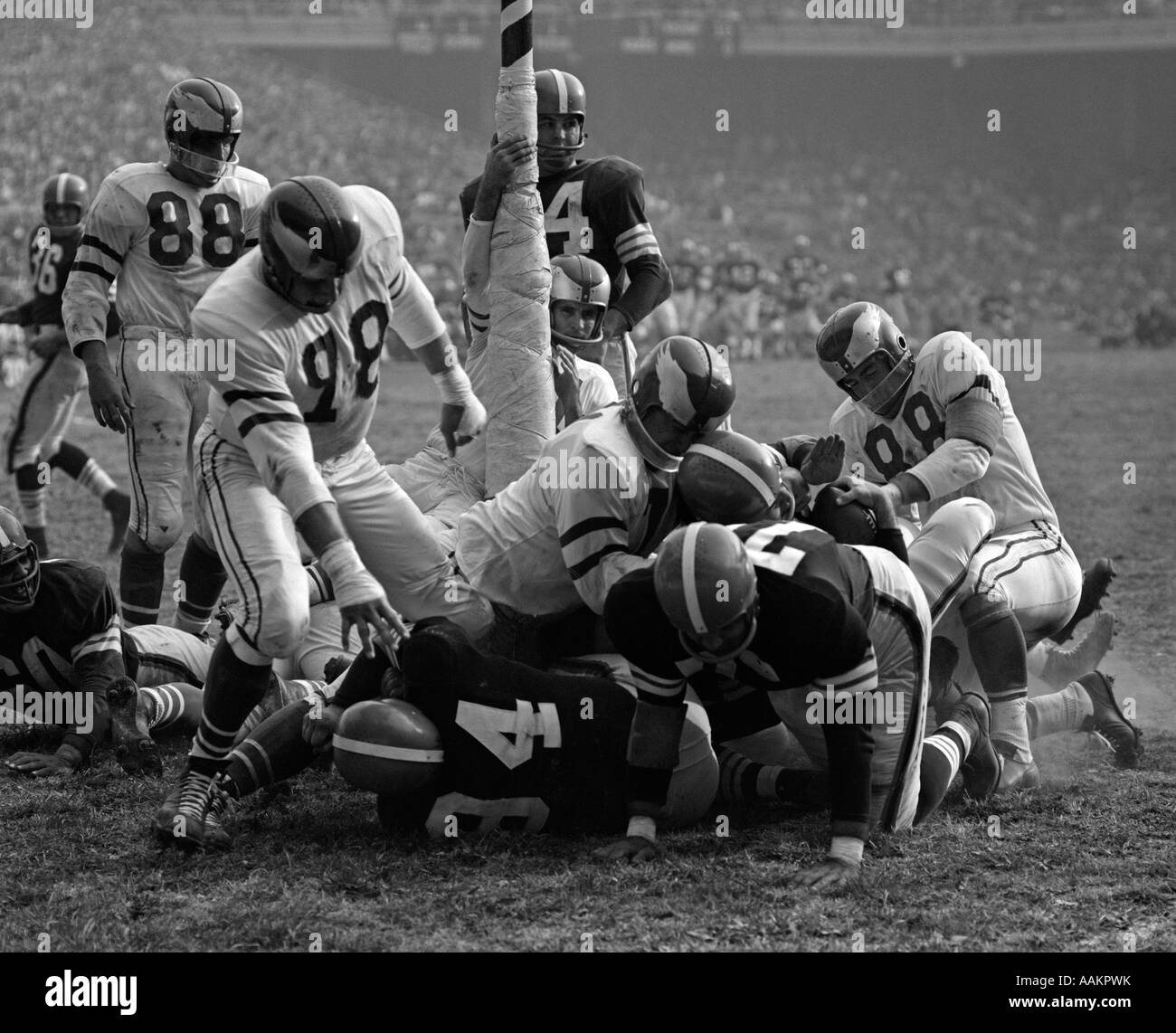 1950s CLOSEUP OF PRO FOOTBALL GAME PILEUP AROUND GOAL POST Stock