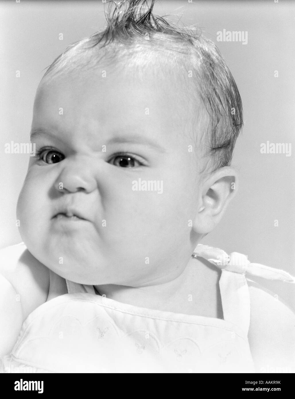 1950s 1960s BABY FACE EXPRESSION ANGRY SAD RETR0 Stock Photo