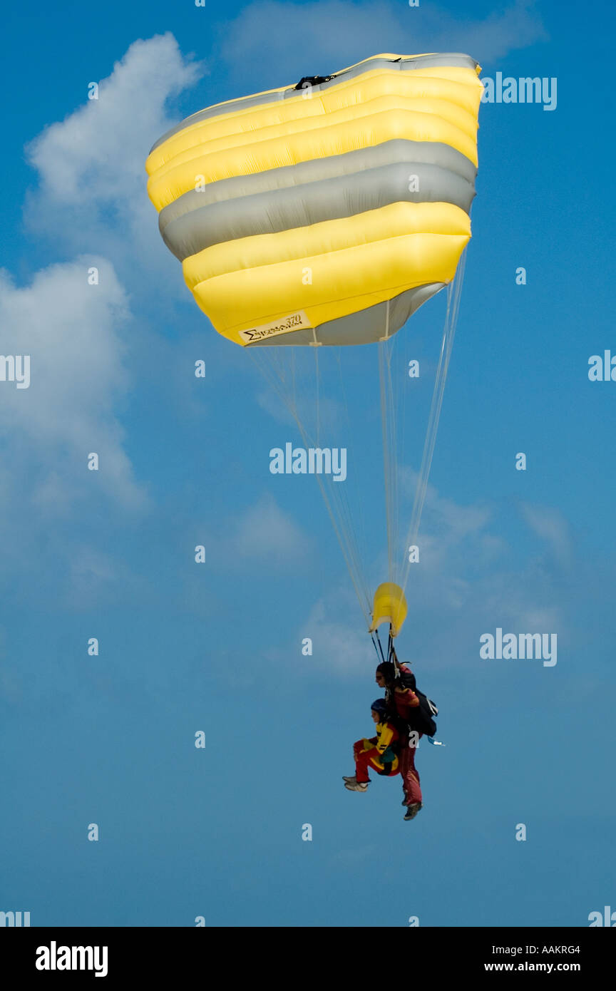 Two skydivers in tandem jump  landing a 'square' ram-air parachute Stock Photo