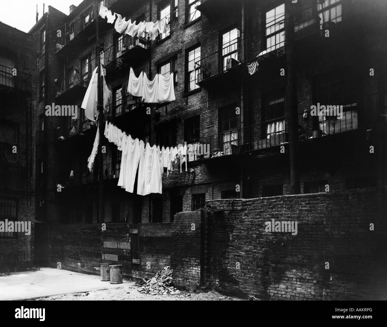 1930s BACK OF TENEMENT HOUSING WITH LAUNDRY HANGING OUT ON CLOTHESLINE Stock Photo