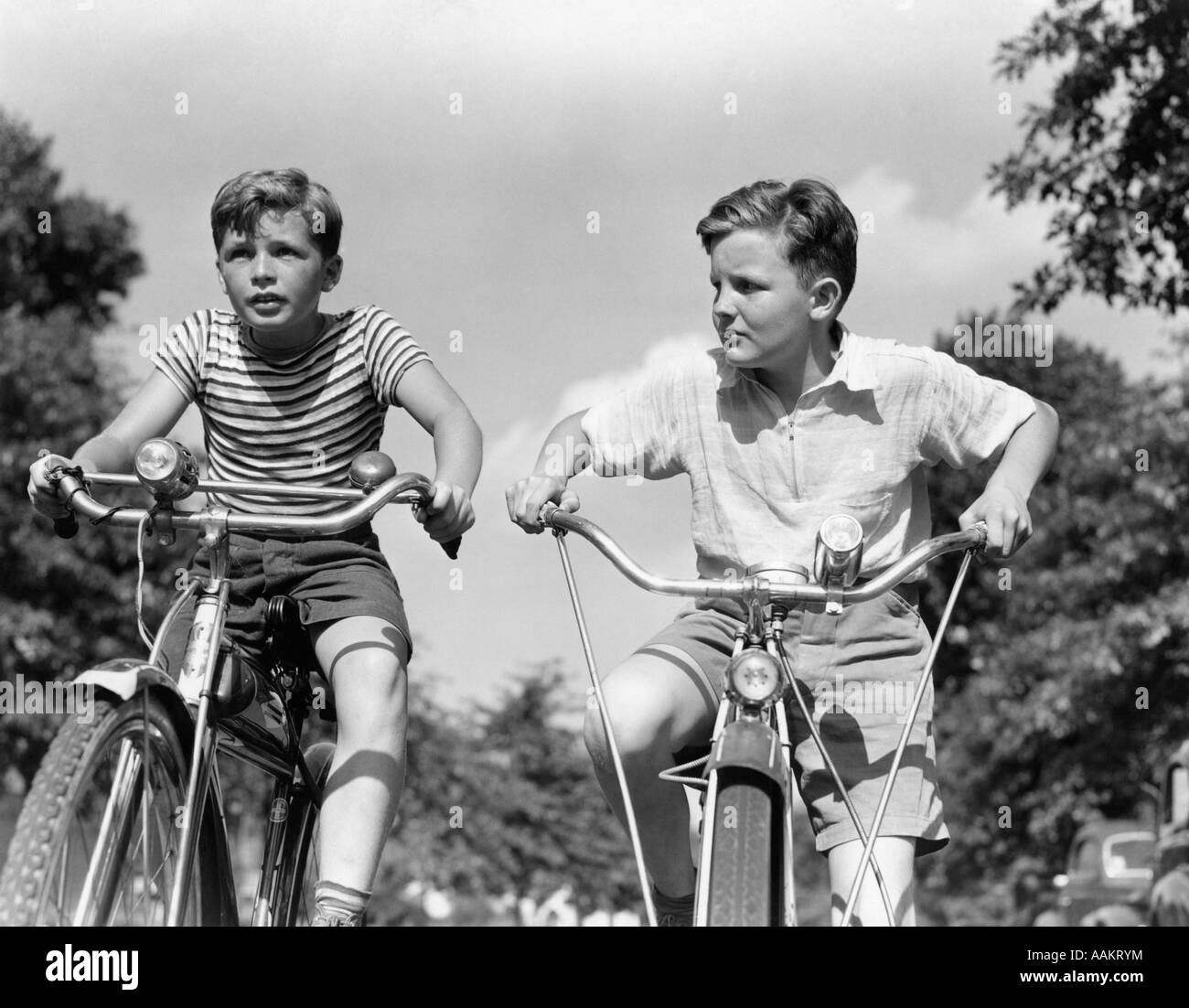 1930s 1940s TWO BOYS RIDING RACING BICYCLES Stock Photo
