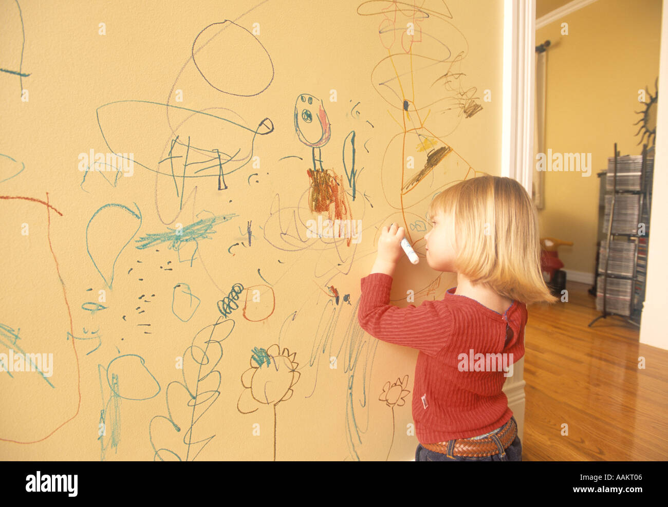 little girl writing on the wall of her house Stock Photo Alamy