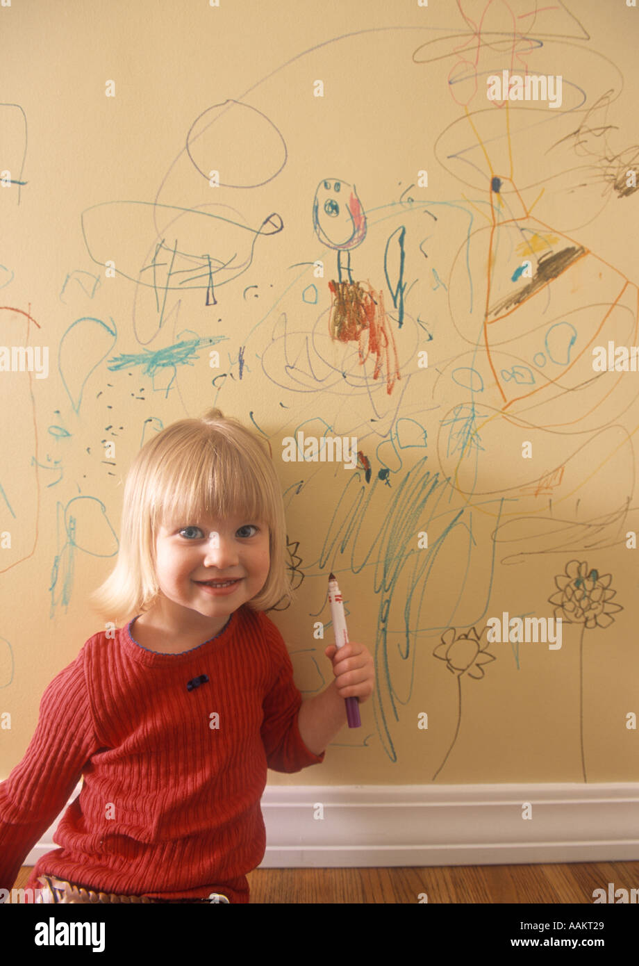 little girl writing on the wall of her house Stock Photo Alamy