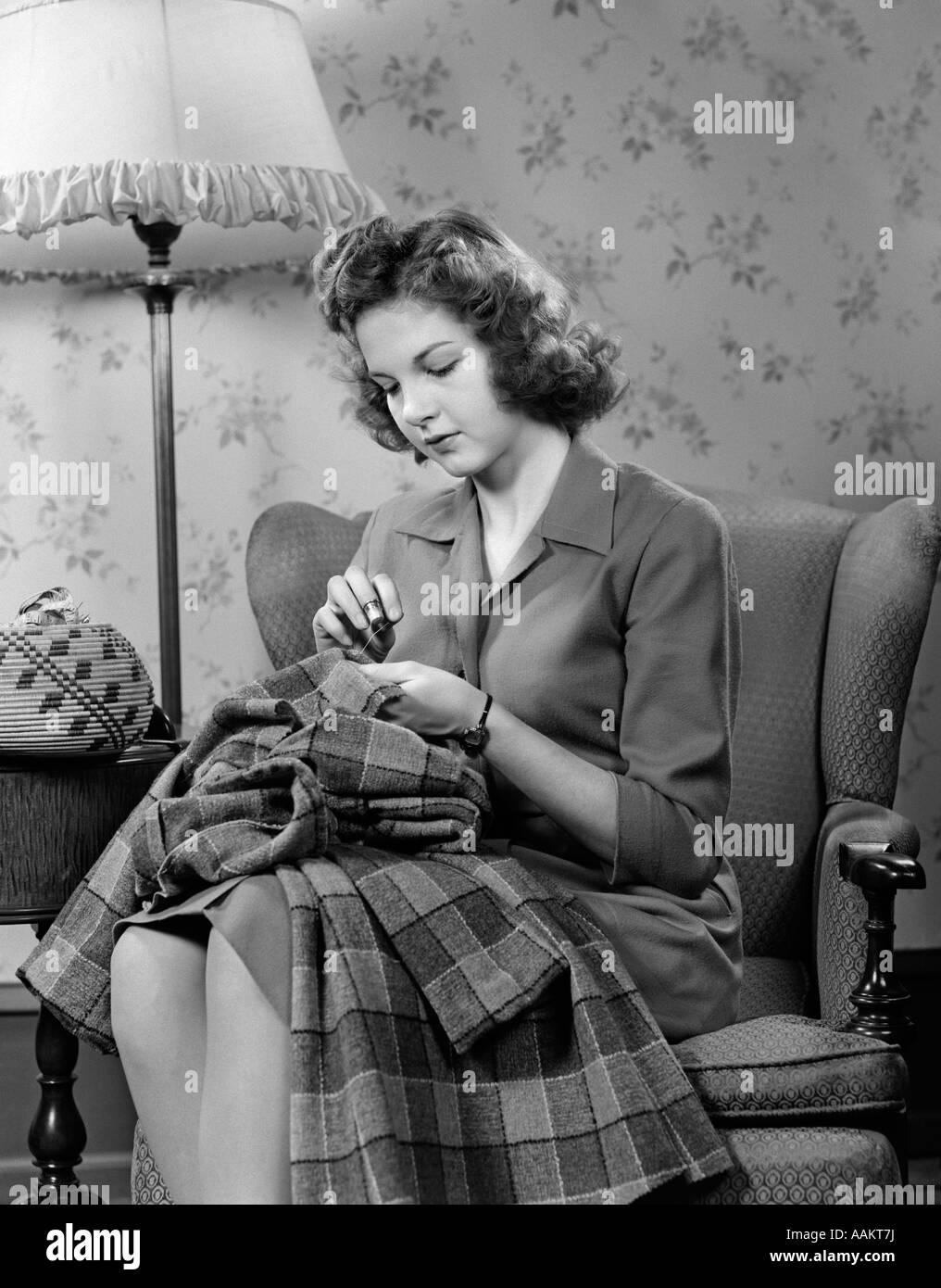 1940s Young Woman Teen Sitting In Chair Under Lamp Sewing