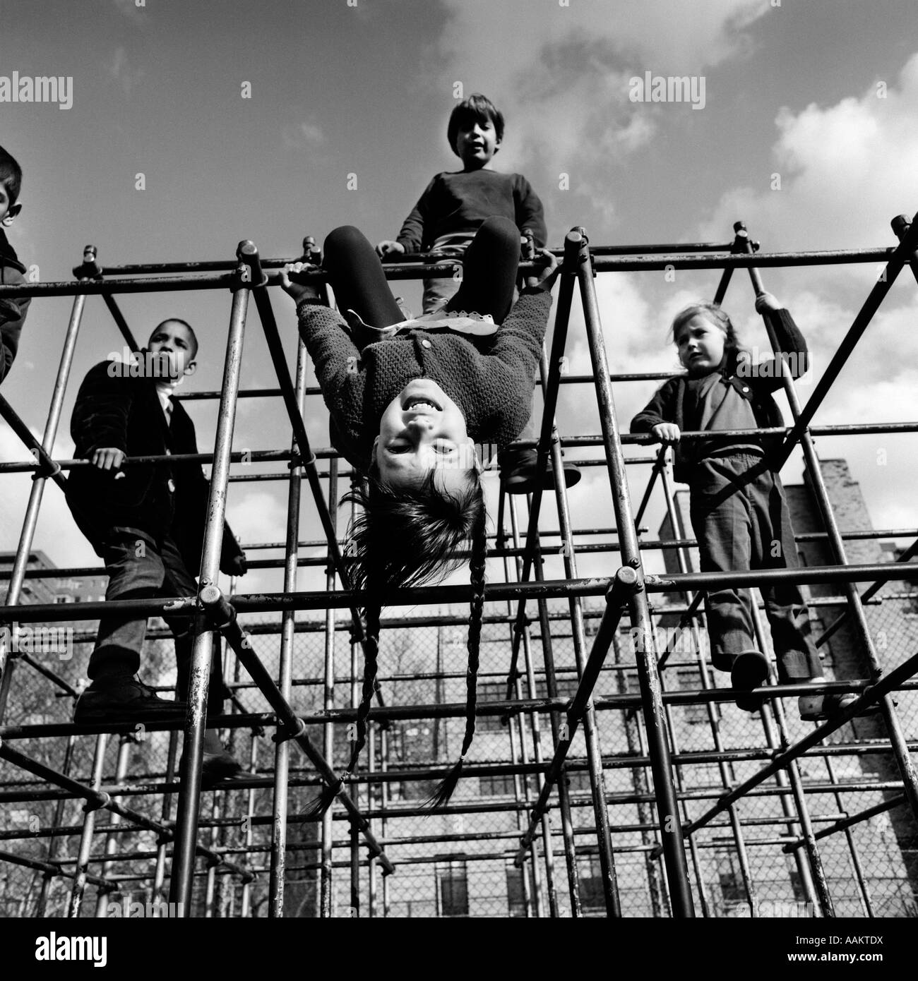 1970s CHILDREN BOYS GIRLS CLIMBING ON BARS OF JUNGLE GYM PLAYGROUND ONE