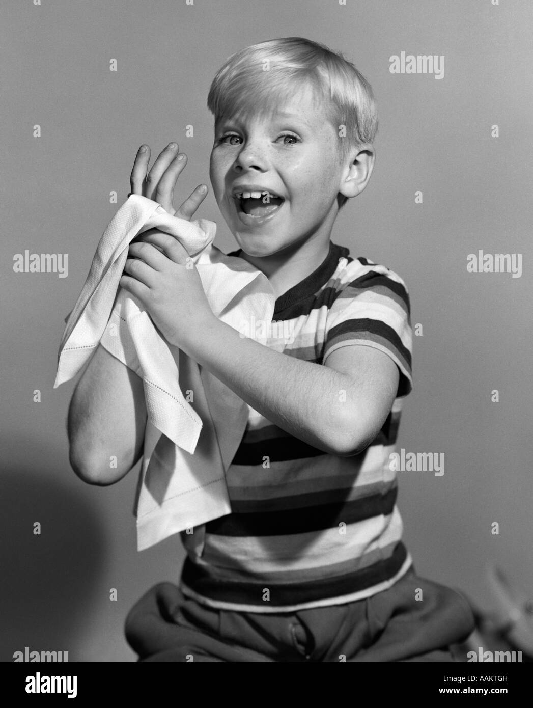 1950s SMILING BLOND BOY WASHING DRYING HANDS TOWEL Stock Photo