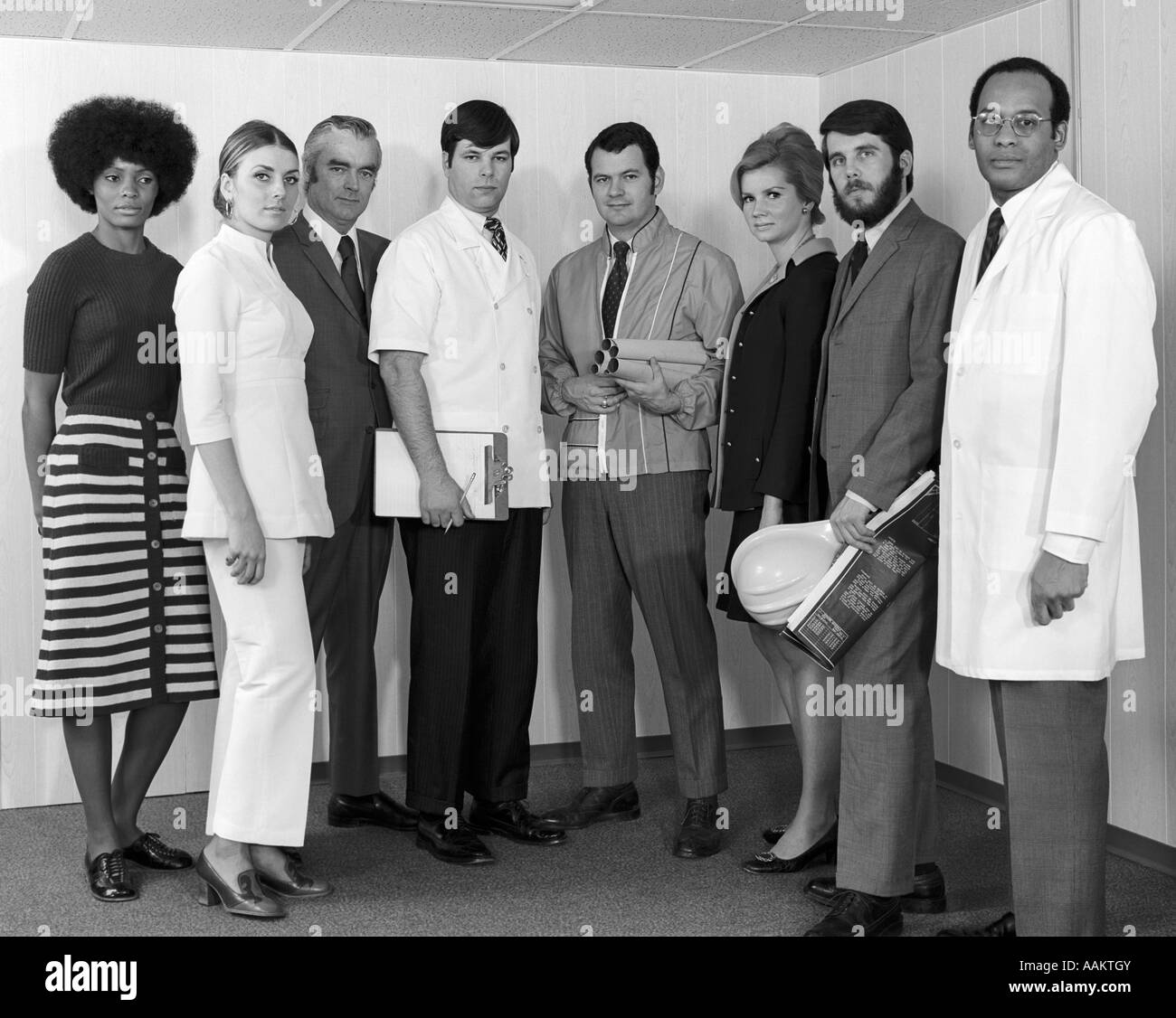 1970s MULTI-ETHNIC LINE-UP OF MEN & WOMEN OF VARIOUS PROFESSIONS WITH SERIOUS EXPRESSIONS Stock Photo