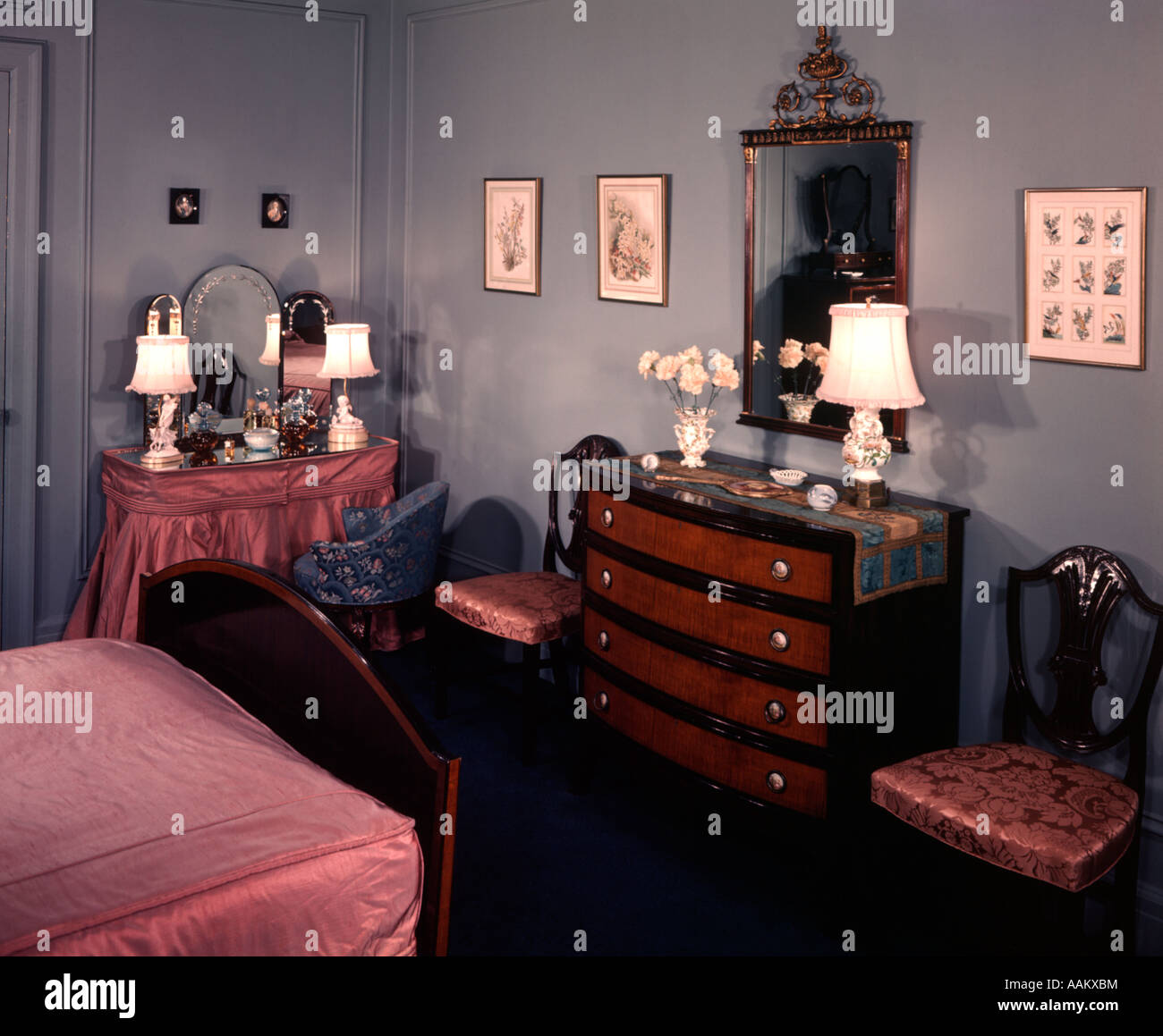 1930s 1940s BEDROOM WITH BLUE WALLS PINK BEDSPREAD AND SKIRTED VANITY
