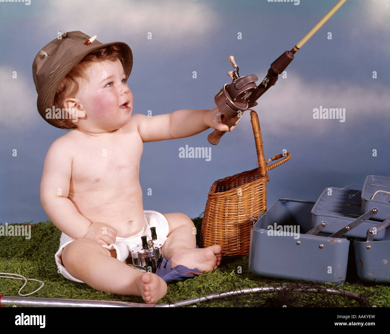 BABY WITH FISHING HAT AND GEAR HOLDING FISHING ROD STUDIO TACKLE BOX CREEL  BASKET Stock Photo - Alamy