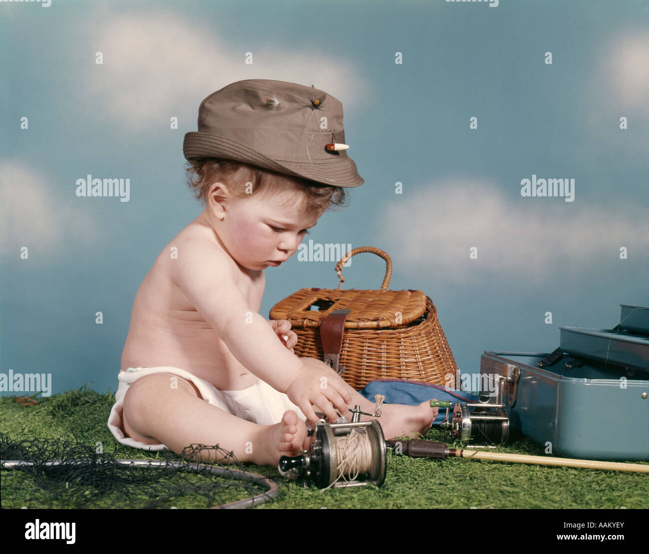 1960s BABY READY TO GO FISHING WEARING HAT SURROUNDED BY TACKLE BOX FISHING  ROD NET BASKET Stock Photo - Alamy