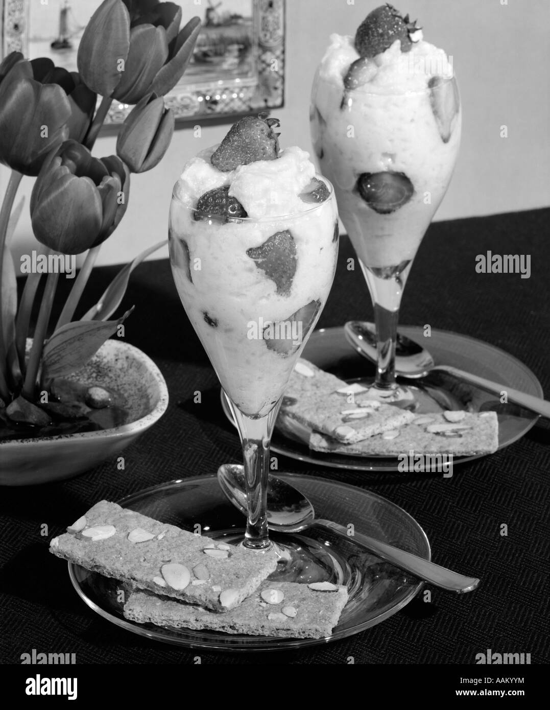 STRAWBERRY DESSERTS IN TULIP SHAPE PARFAIT GLASSES WITH DUTCH ALMOND COOKIES Stock Photo