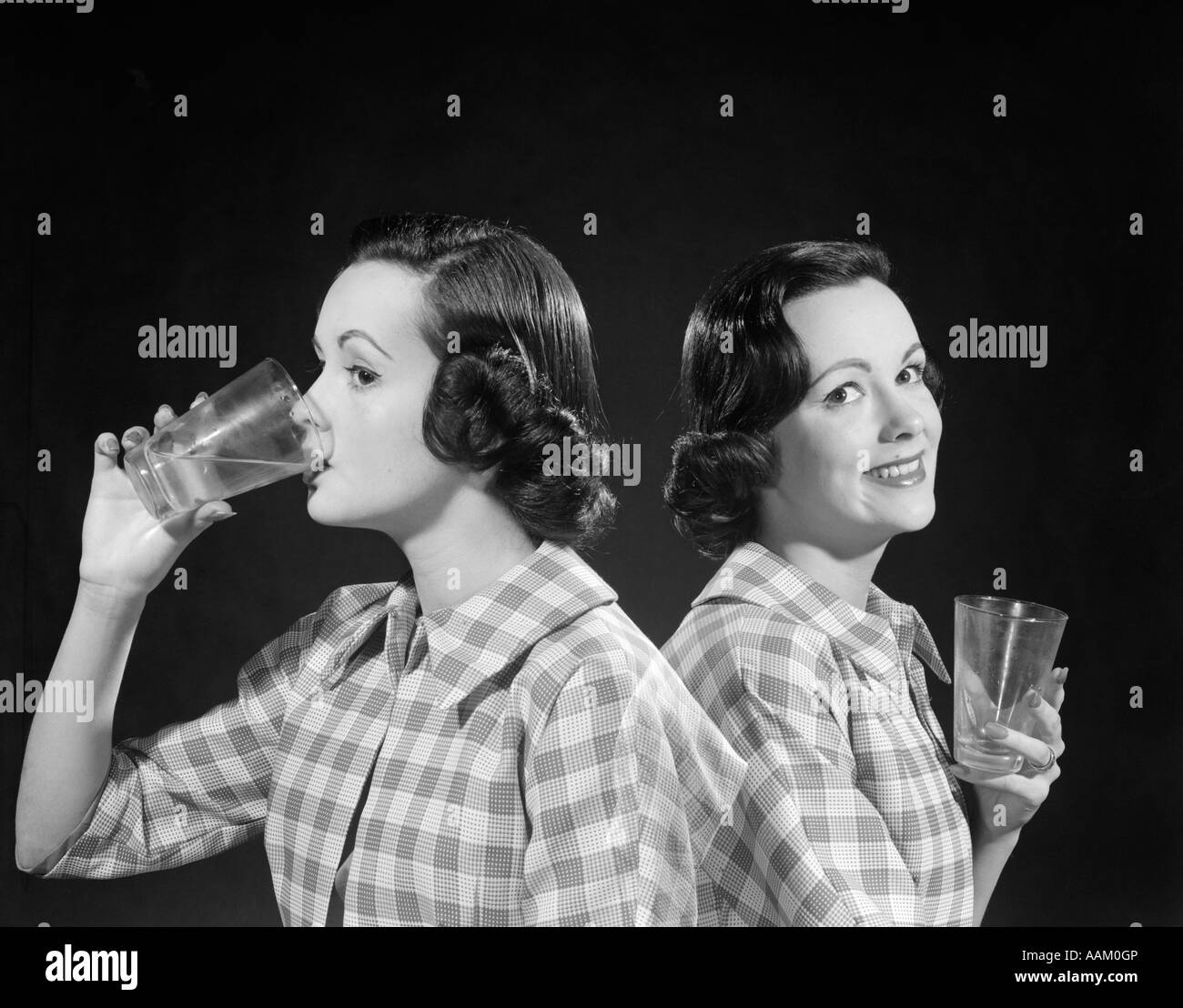 1950s 1960s DOUBLE EXPOSURE OF A WOMAN IN CHECKERED SHIRT DRINKING FROM A GLASS & SMILING AFTERWARD LOOKING AT CAMERA Stock Photo