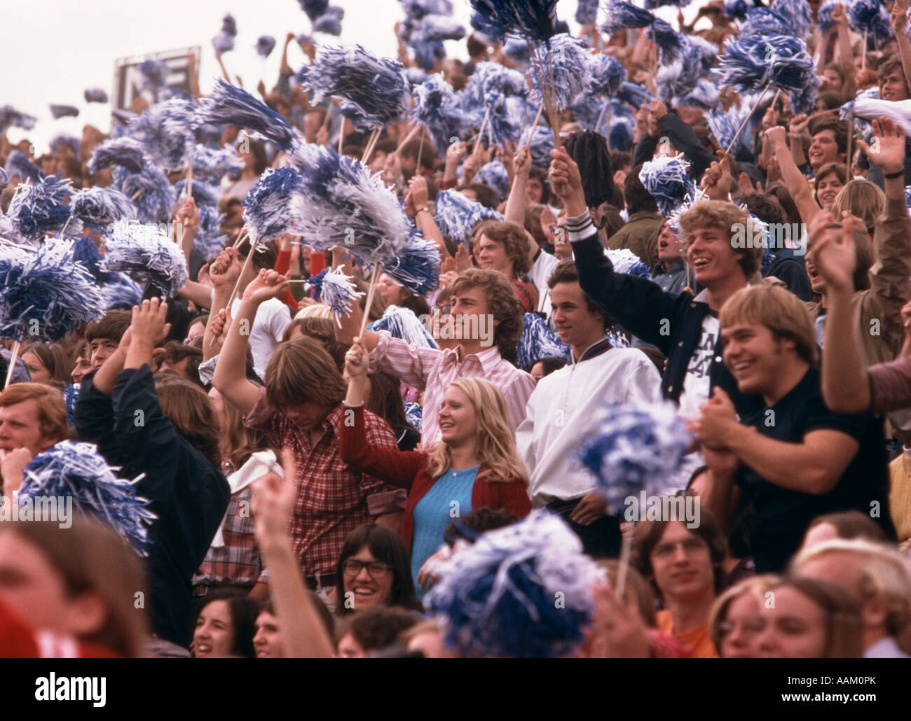 1970s CROWD COLLEGE STUDENTS FOOTBALL GAME WAVING POM POMS CHEERING Stock  Photo - Alamy