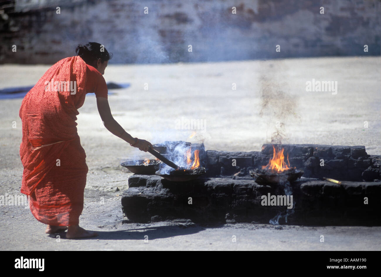 Lighting PUJA FIRES near the MAIN TEMPLE in the PASHUPATINATH TEMPLE