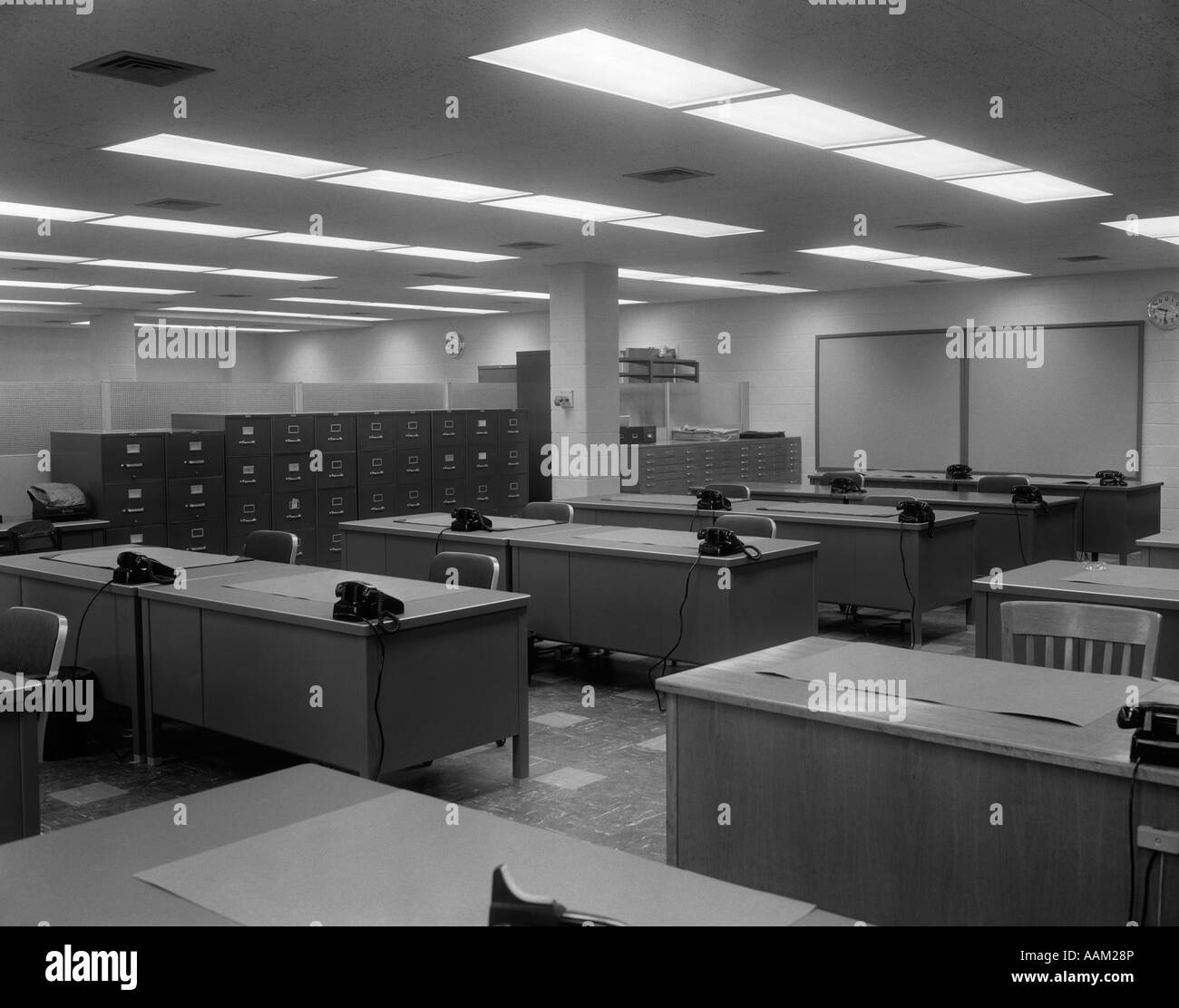 1950s 1960s OFFICE WITH DESKS BLACK PHONES AND FILE CABINETS Stock Photo