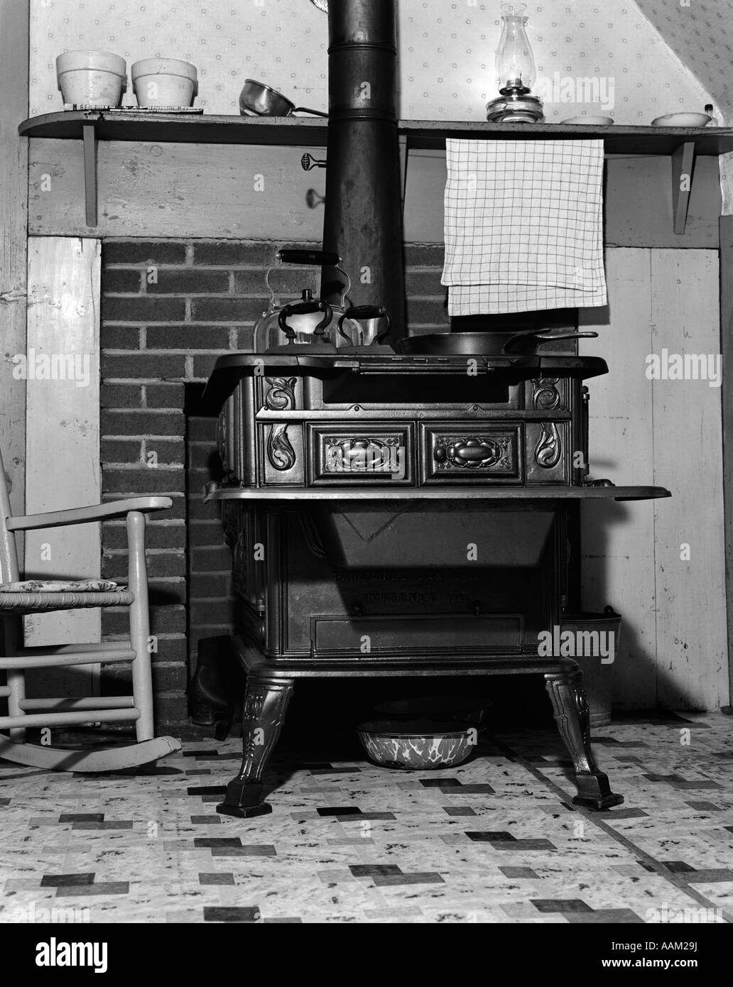 1920s 1930s KITCHEN INTERIOR FOCUSED ON WOOD BURNING STOVE Stock Photo