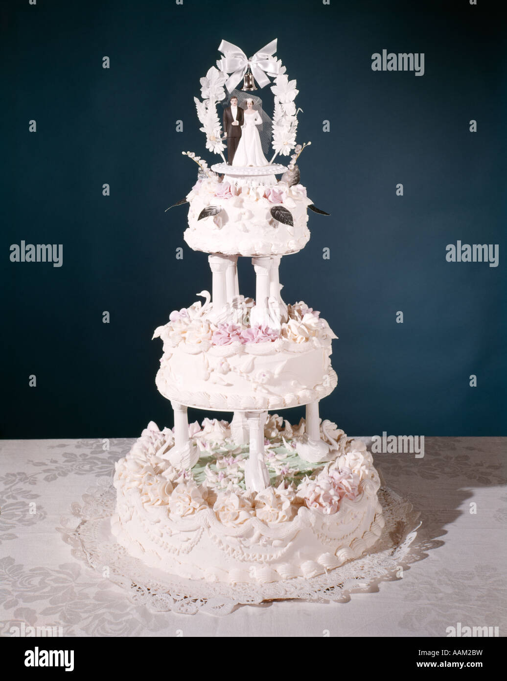 THREE TIER WEDDING CAKE WITH WHITE AND PINK FROSTING WEDDING COUPLE ON