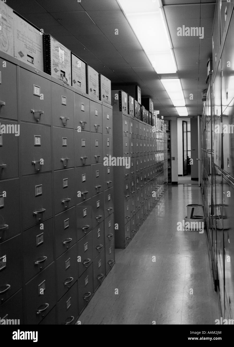 1970s OFFICE INTERIOR CORRIDOR LINED WITH METAL FILE CABINETS BOXES STORAGE STEP STOOL Stock Photo