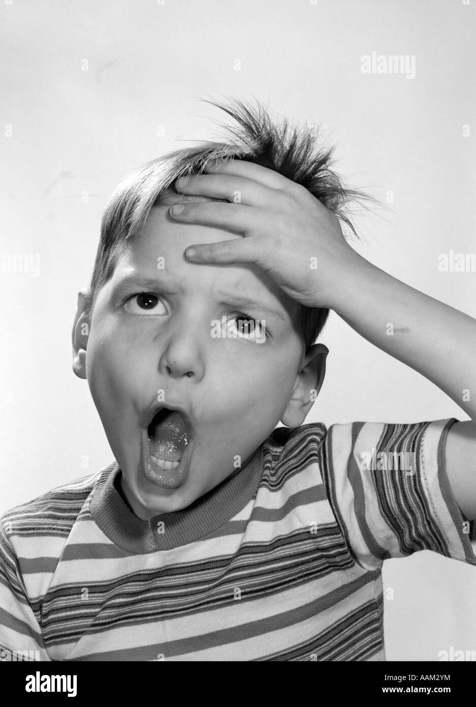 1960s 1950s BOY HAND TO FOREHEAD FUNNY SURPRISED OVERWHELMED EXPRESSION Stock Photo