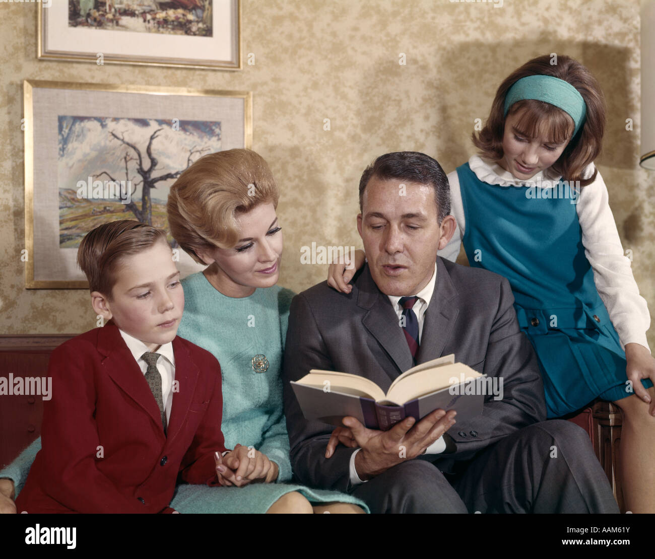 1960 1960s RETRO FAMILY READING MOTHER FATHER SON DAUGHTER Stock Photo ...