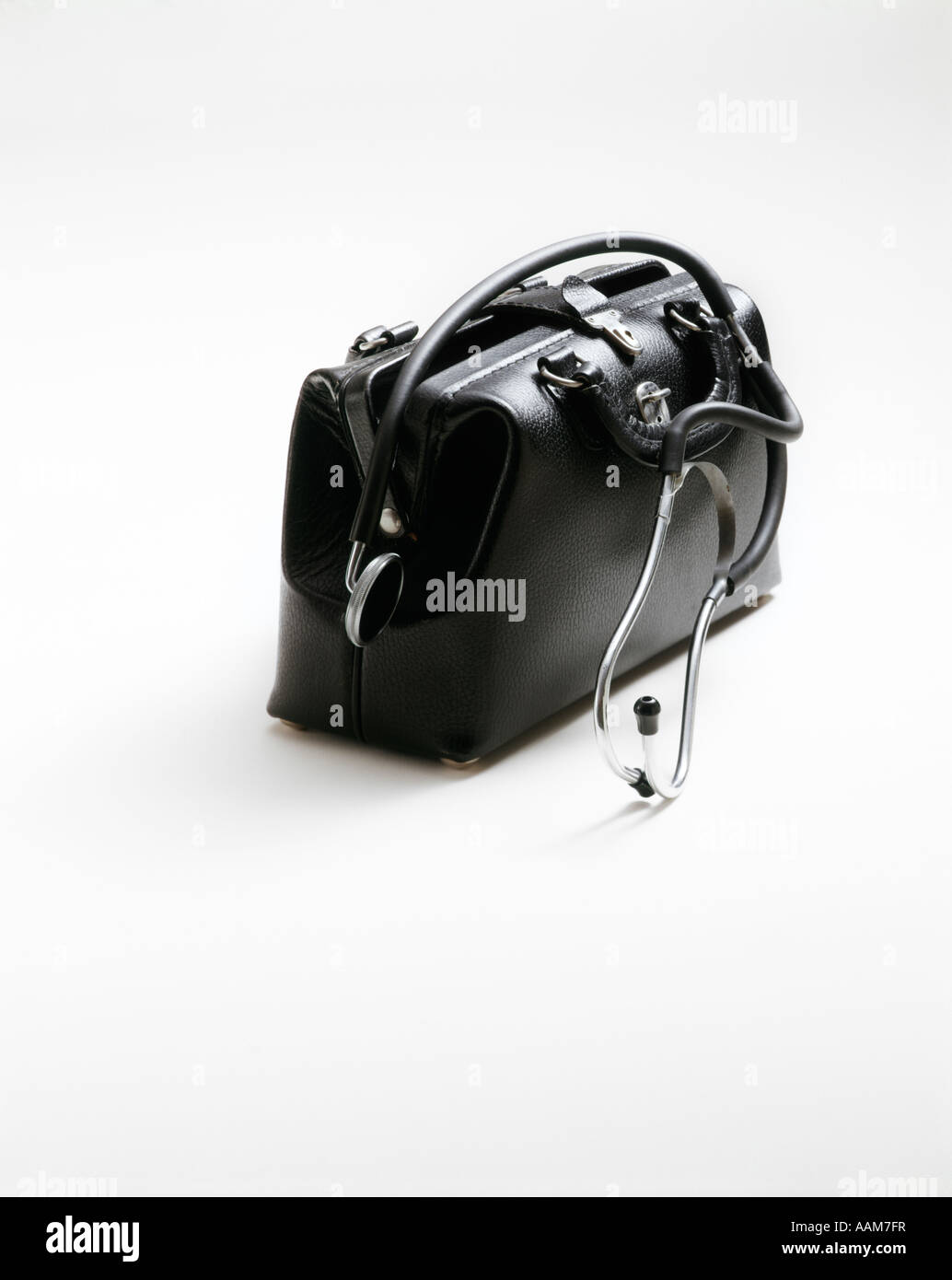 BLACK LEATHER DOCTORS DOCTOR BAG WHITE BACKGROUND STETHOSCOPE OVER BAG