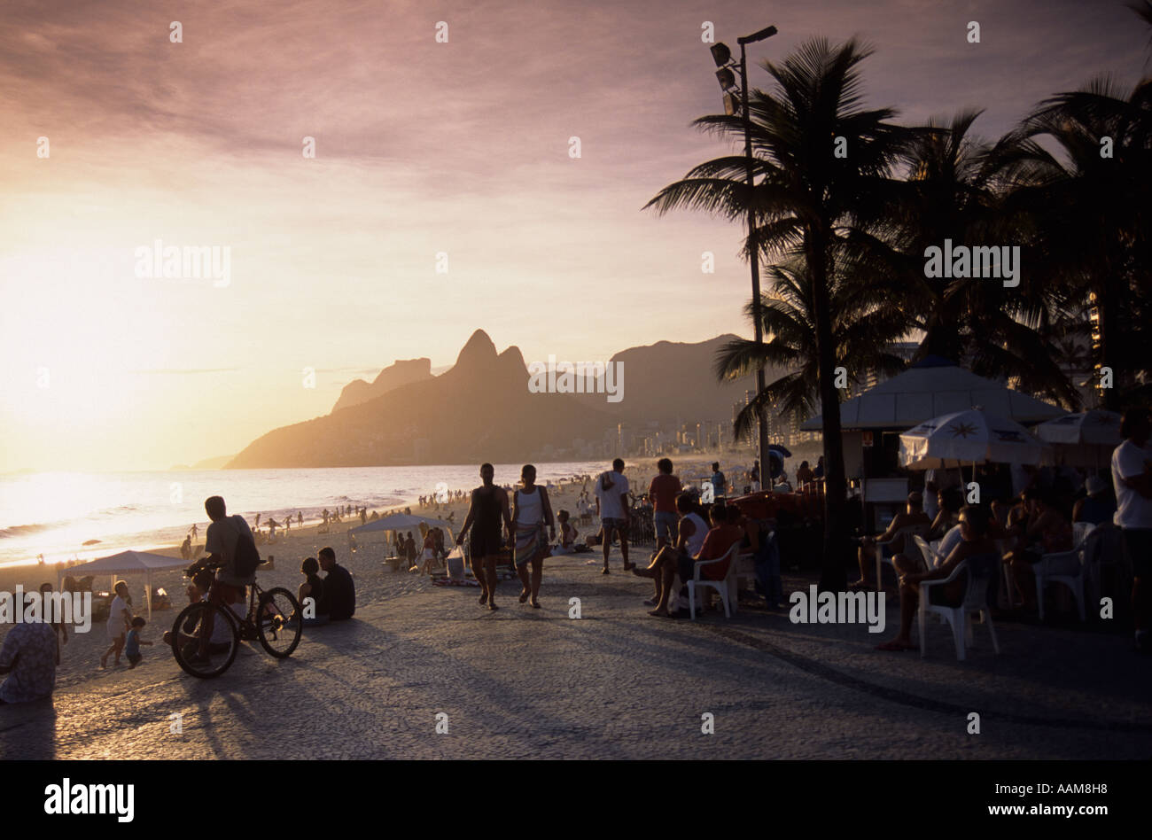 Sunset at Ipanema beach Rio de Janeiro Brazil People enjoying leisure time at Ipanema calçadão Stock Photo