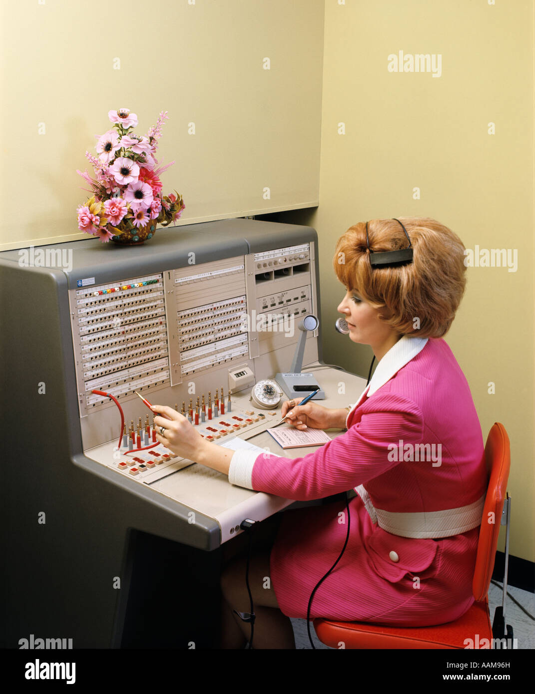 1970s WOMAN WORKING AT PBX TELEPHONE SWITCHBOARD Stock Photo