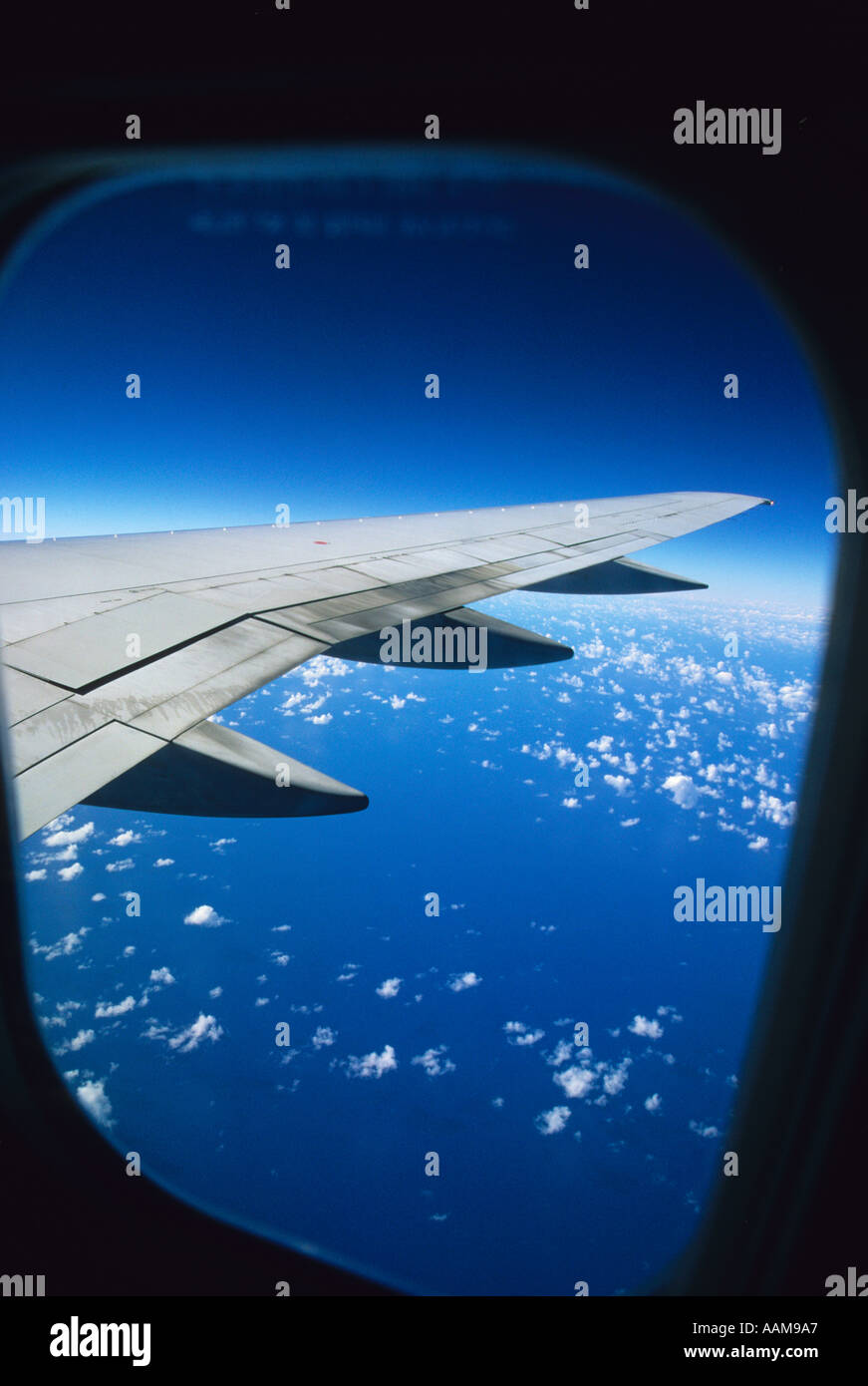 the view of an aircraft wing out the window of a passenger airliner Stock Photo Alamy