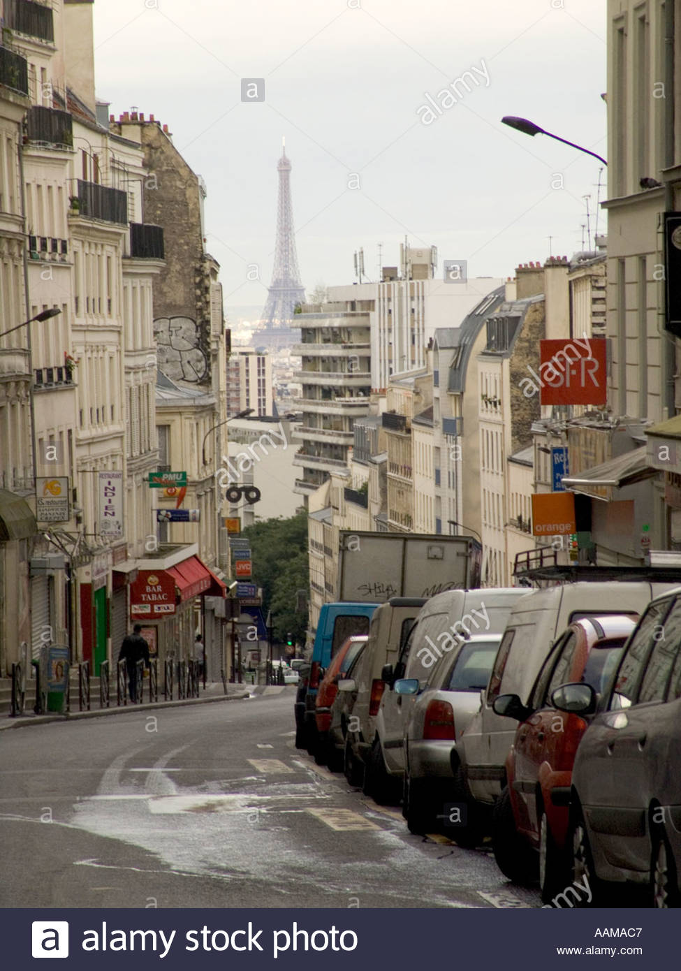 Paris street Rue de Belleville with Eiffel tower in the distance Stock