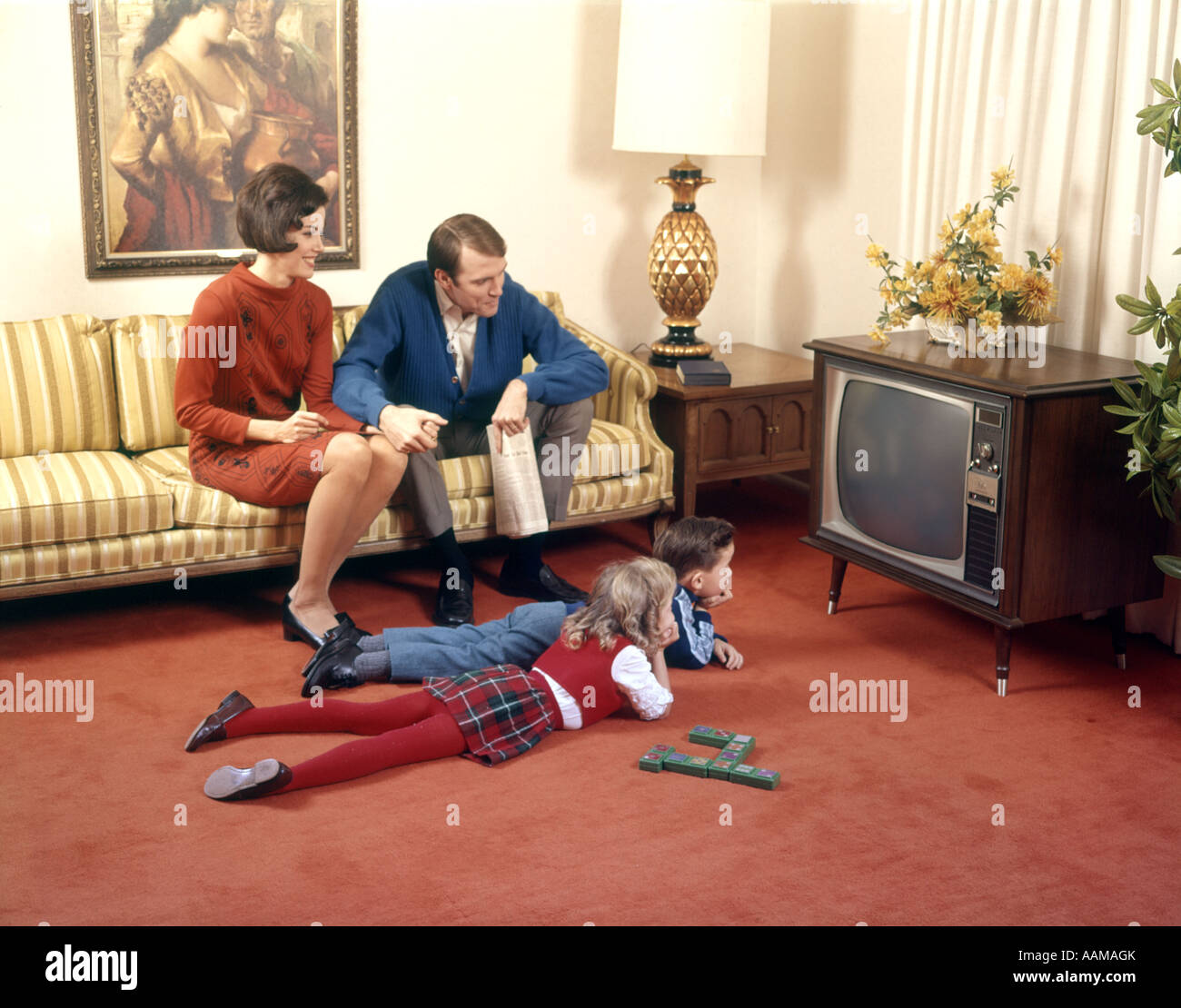 1960s FAMILY IN LIVING ROOM WATCHING TV FATHER MOTHER SISTER BROTHER Stock Photo