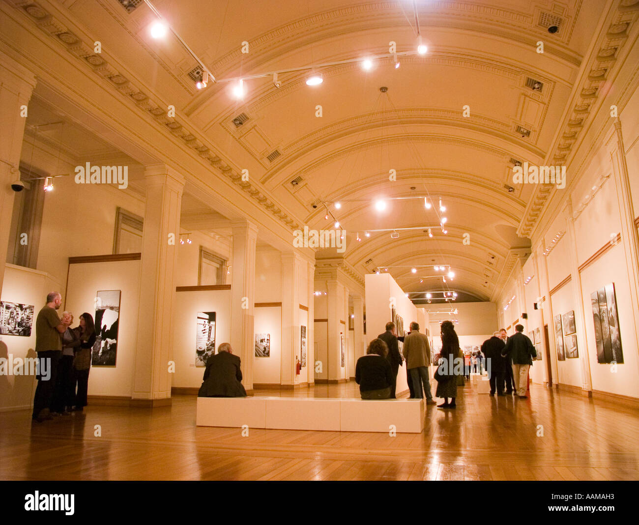 Interior of the national library of wales - people in art gallery exhibition of photographs by Rhodri Jones - Back / Yn ol Stock Photo