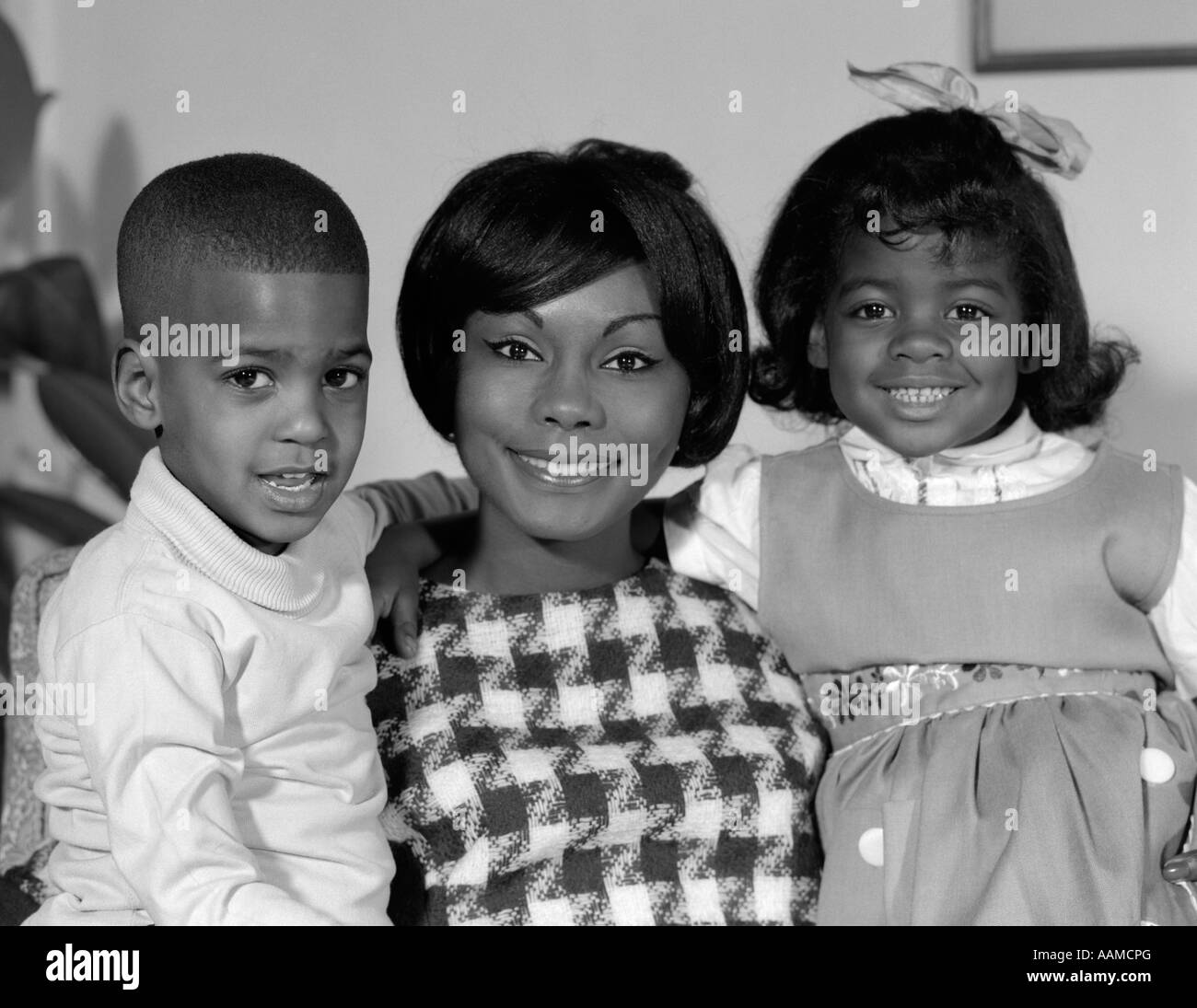 1960s PORTRAIT OF AFRO-AMERICAN MOTHER WITH ARMS AROUND SON & DAUGHTER Stock Photo