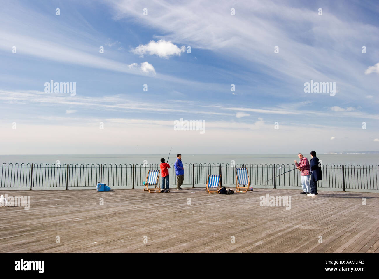 Man giving fishing lessons and tuition on Hastings pier Stock Photo