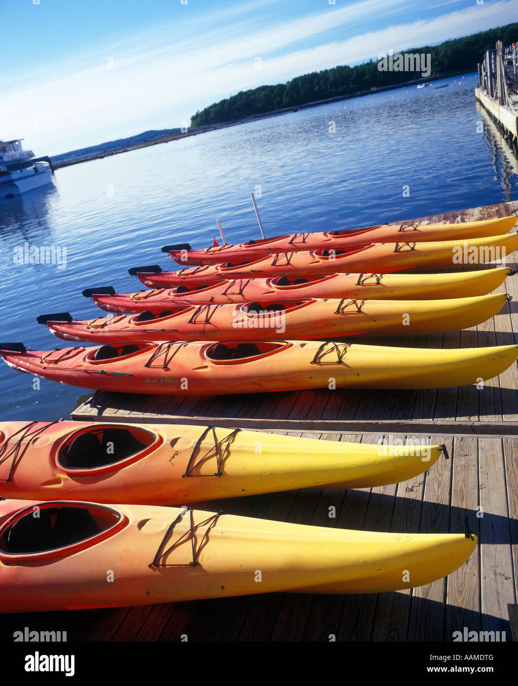 BAR HARBOR MOUNT DESERT ISLAND ME ROW OF KAYAKS ON DOCK IN HARBOR USED FOR GUIDED TOURS AROUND