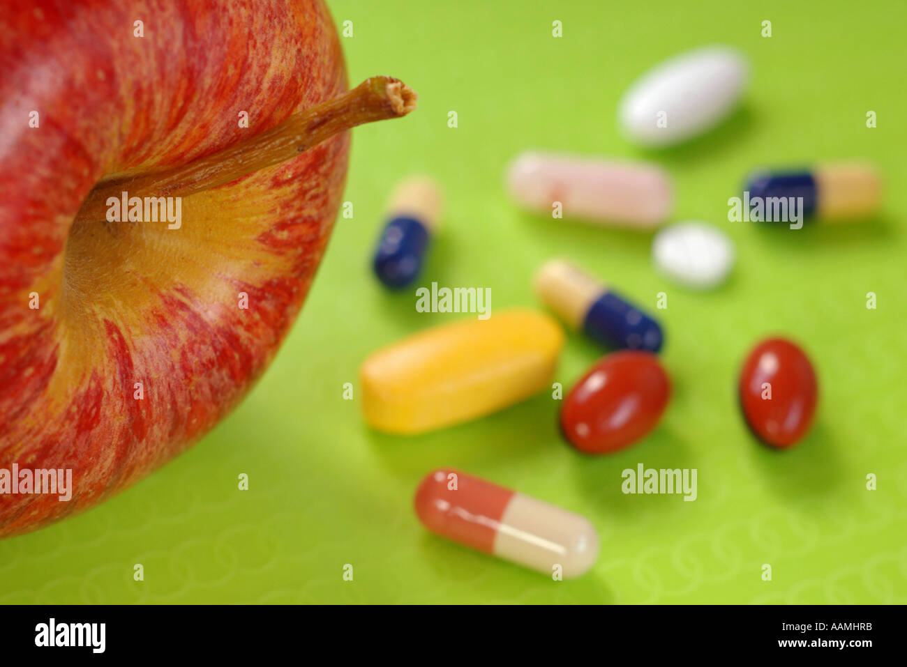 Apple with a selection of pills Stock Photo