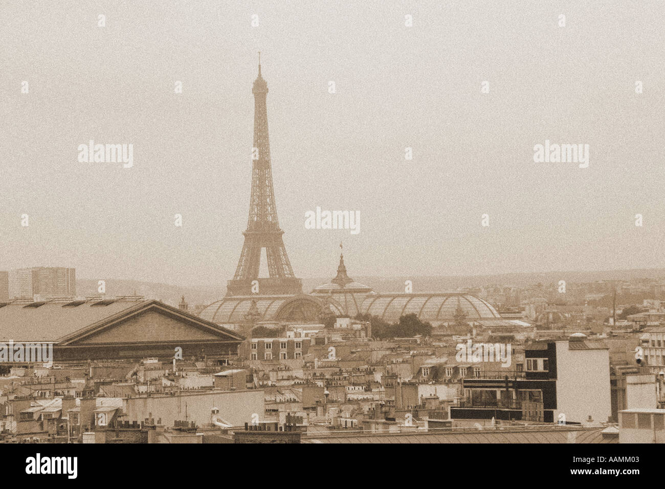 Sepia landscape shot of Eiffel Tower across rooftops of Paris France Stock Photo