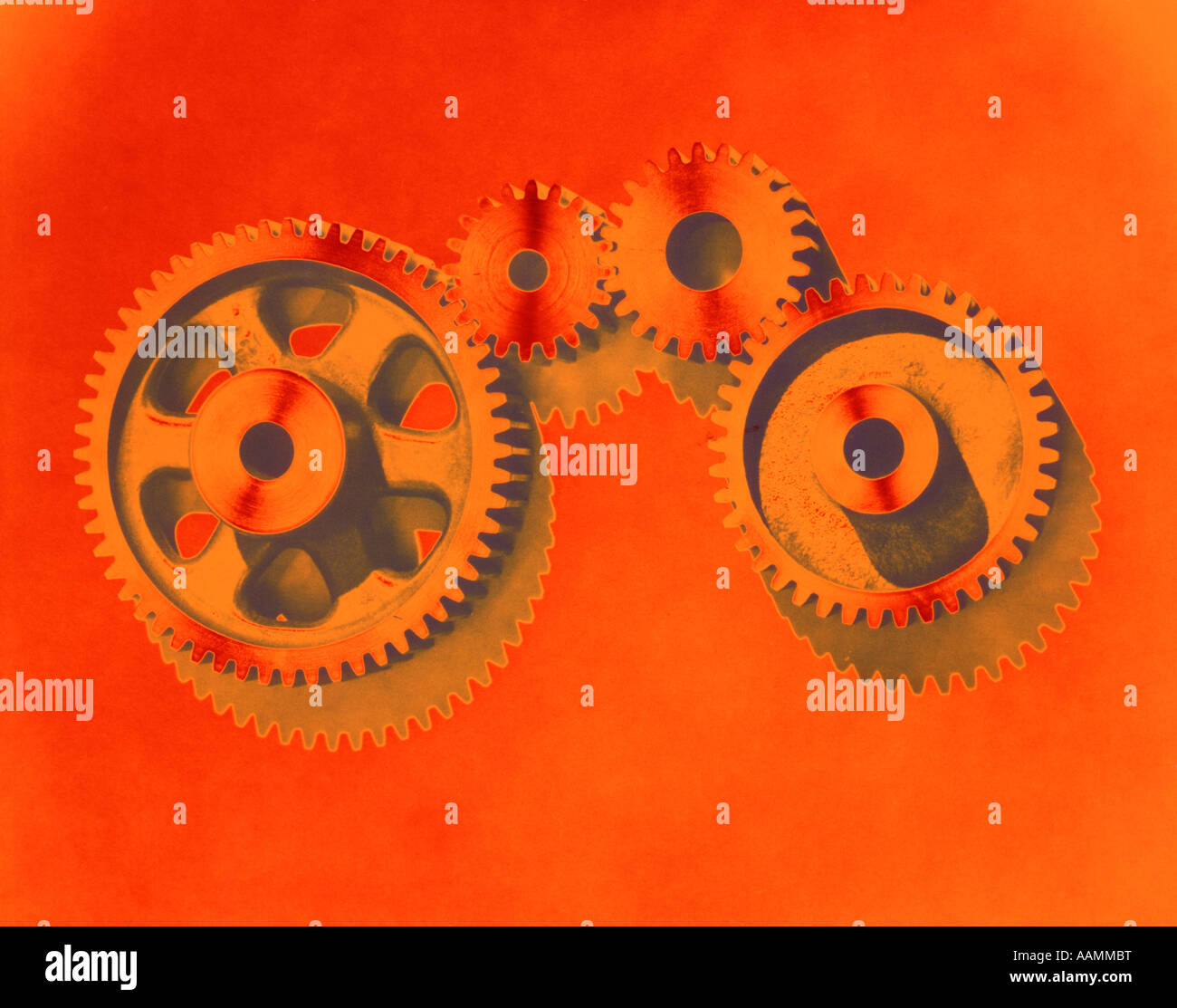 1970s PATTERN OF GEARS POSTERIZED COLOR ORANGE GREEN INDUSTRY Stock Photo