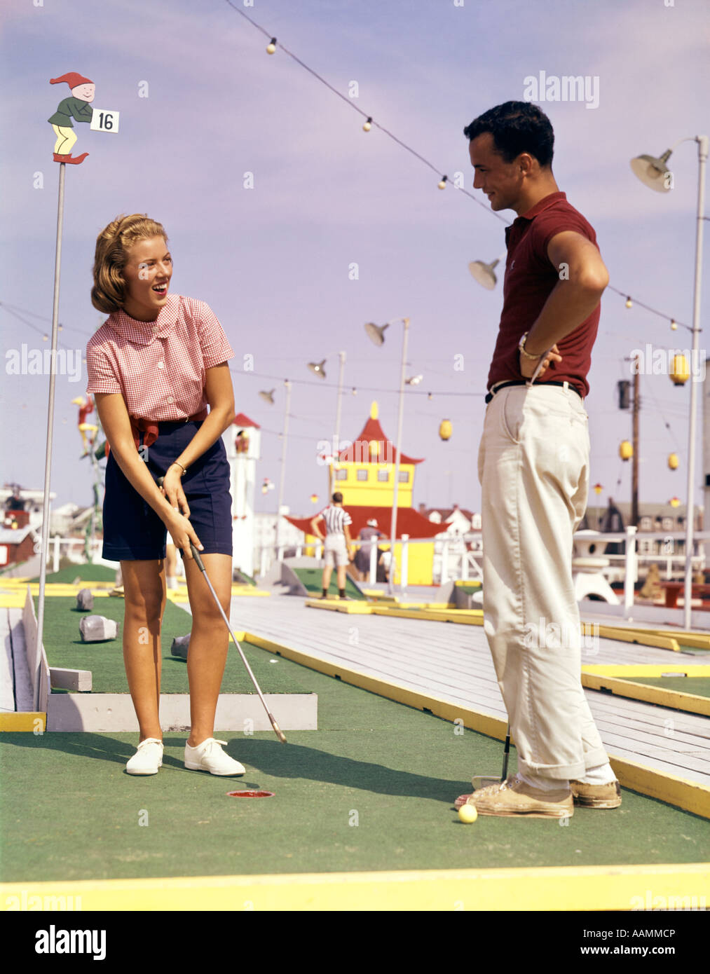 1960s YOUNG COUPLE PLUING MINIATURE GOLF Stock Photo