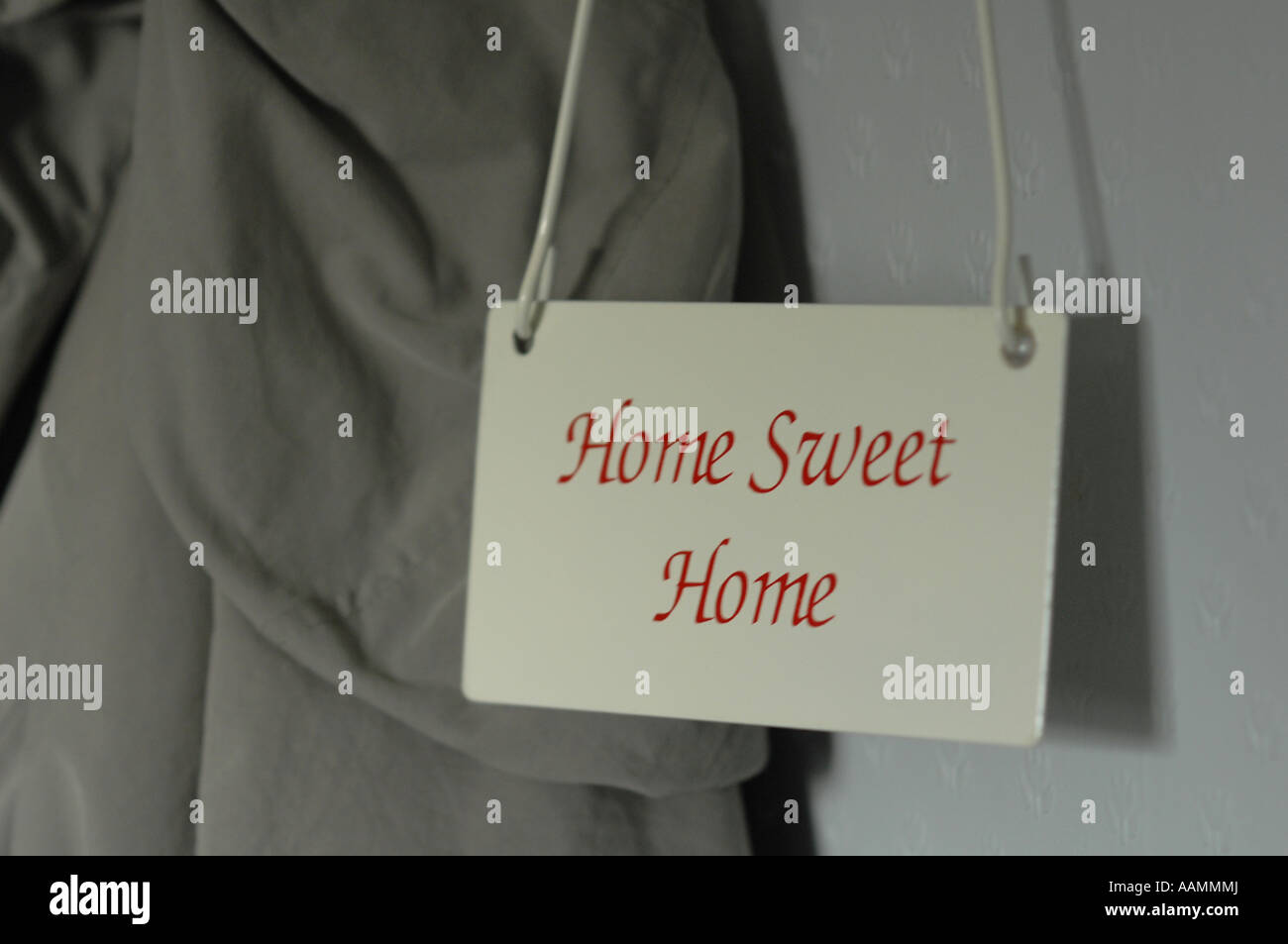 Home sweet home sign hangs in a hallway. Stock Photo