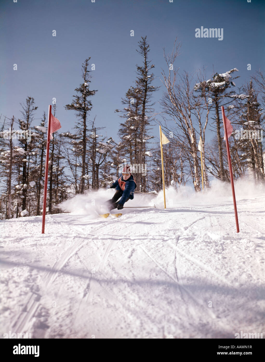 1960 1960s MAN IN BLUE OUTFIT DOWNHILL SKI RACE BETWEEN FLAGS GATES
