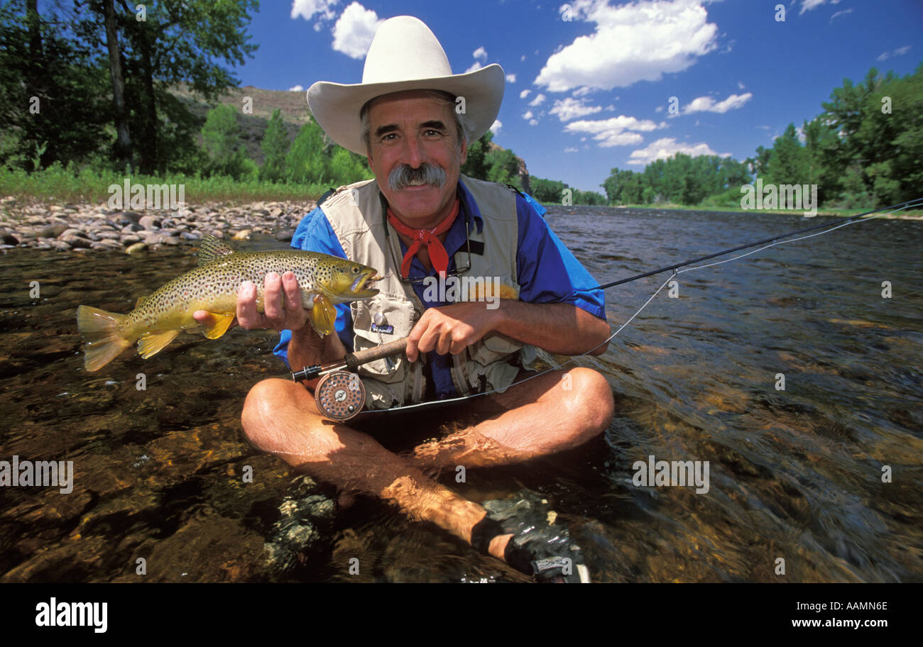 MONTANA Fisherman sitting in river holding a Brown Trout Big Hole River Montana Stock Photo Alamy MONTANA Fisherman sitting in river holding a Brown Trout Big Hole River Montana Stock Photo Alamy