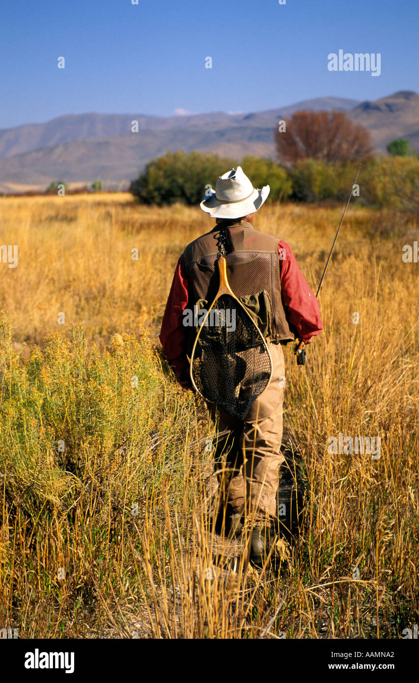 IDAHO Fisherman walking down trail to favorite fishing spot Silver Creek Sun Valley Hemingways favorite trout stream Stock Photo