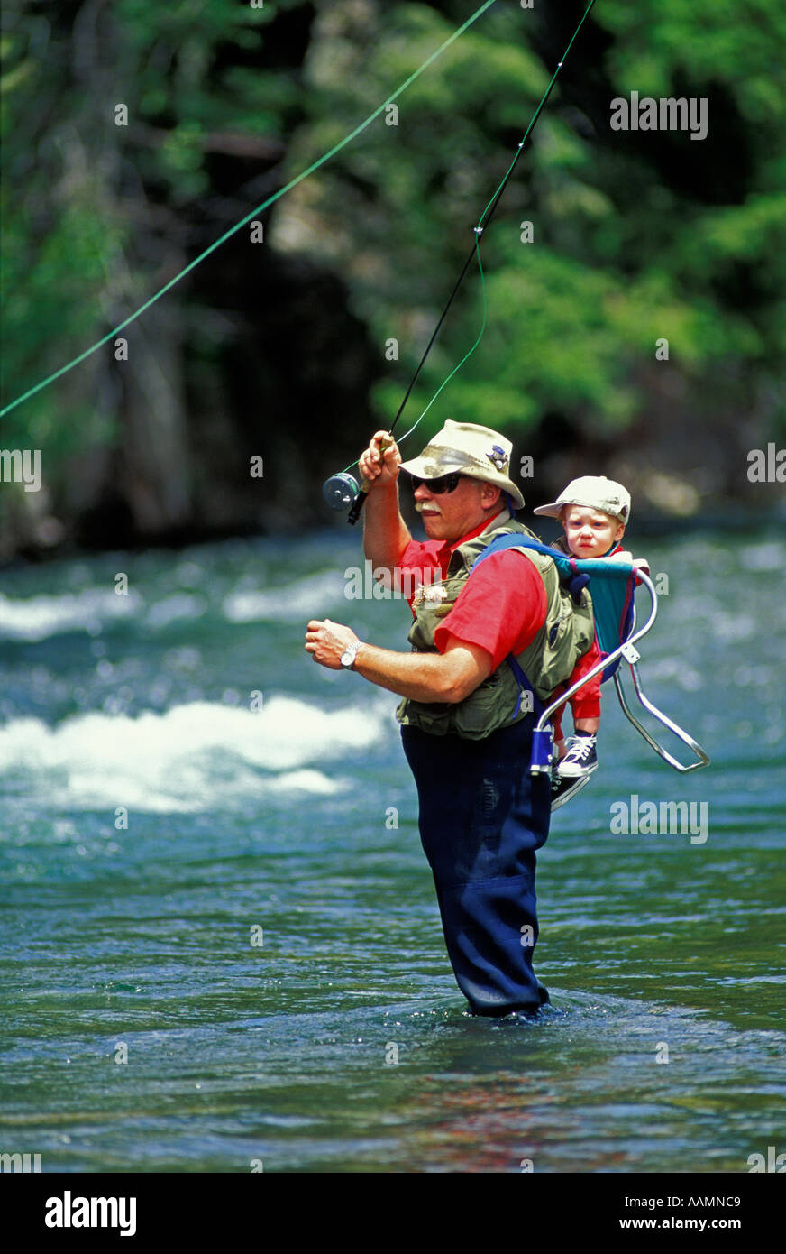 IDAHO Man Fly Fishing in Mountain Lake Sawtooth Mountains near Stanley Concept fun outdoors wilderness People adult man Stock Photo